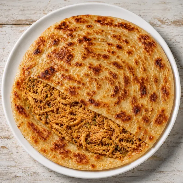 Chicken paratha with visible spiced chicken filling